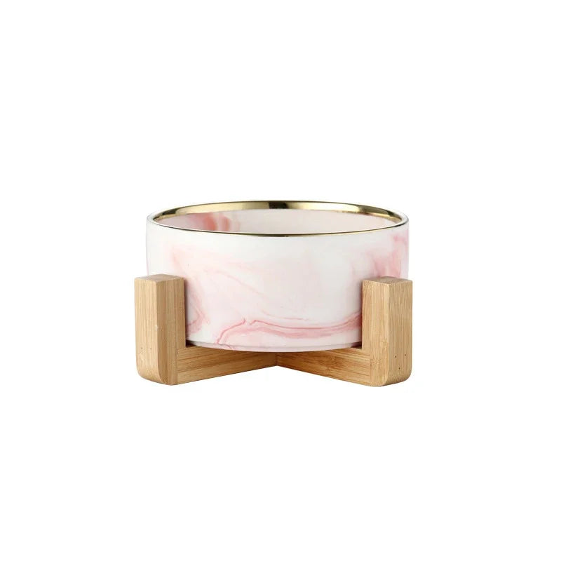 Gamelle chien rose avec liserait or sur un support bois. image produit Boutiquechien