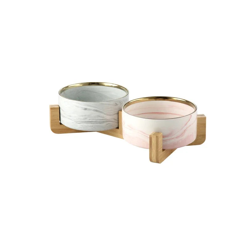 gamelle double pour chien design avec support en bois. Les gamelles sont grises et rose avec un liserait d'or. Image produit Boutiquechien