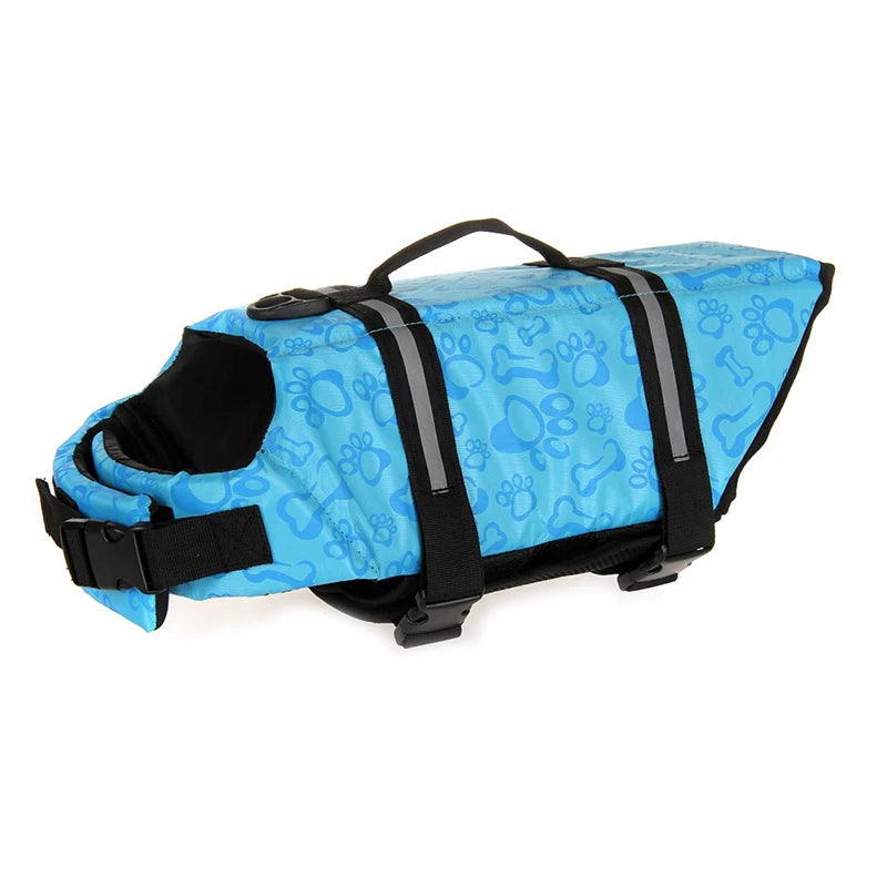 harnais de sauvetage pour chien bleu avec formes de pattes avec des points. Sur un harnais il y a une poignée de couleur noir avec des sangles noir. Image produit Boutiquechien