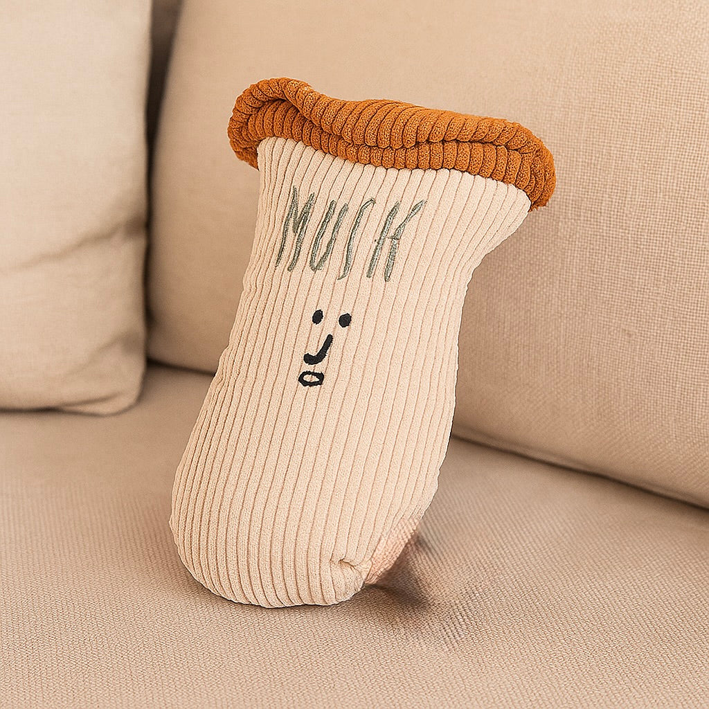 peluche en forme de champignon blanc posé sur un canapé de couleur gris. Image produit Boutiquechien