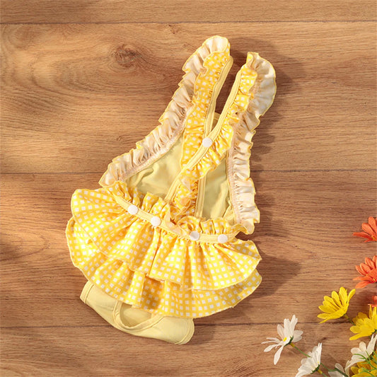 Culotte tutu pour les chiens de couleurs jaunes posé sur un sol en bois. Image produit Boutiquechien