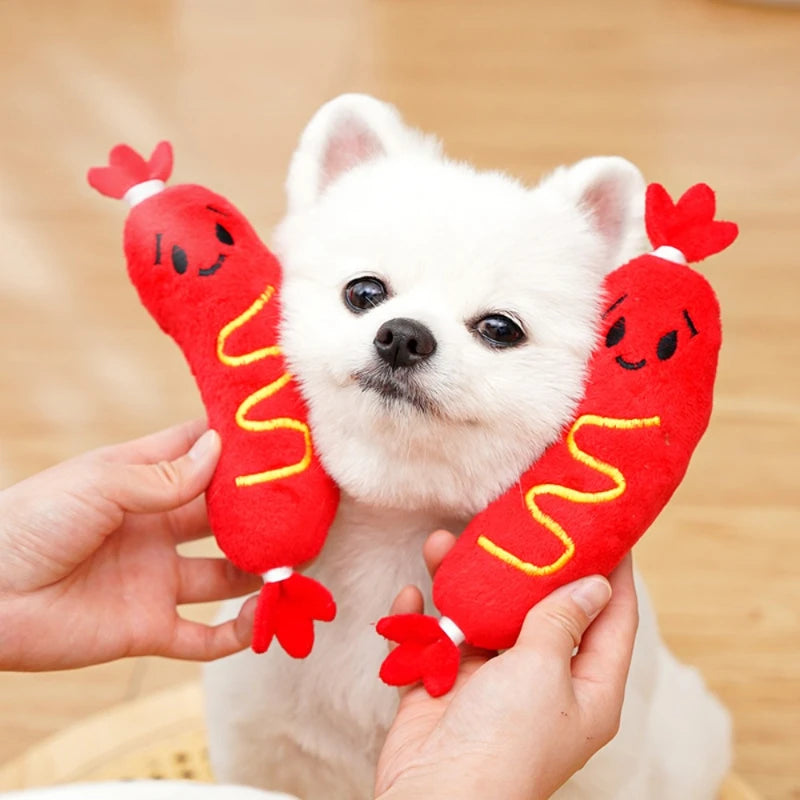Jouet pour chiot 1 mois en forme de saucisse près d'un chien blanc Image