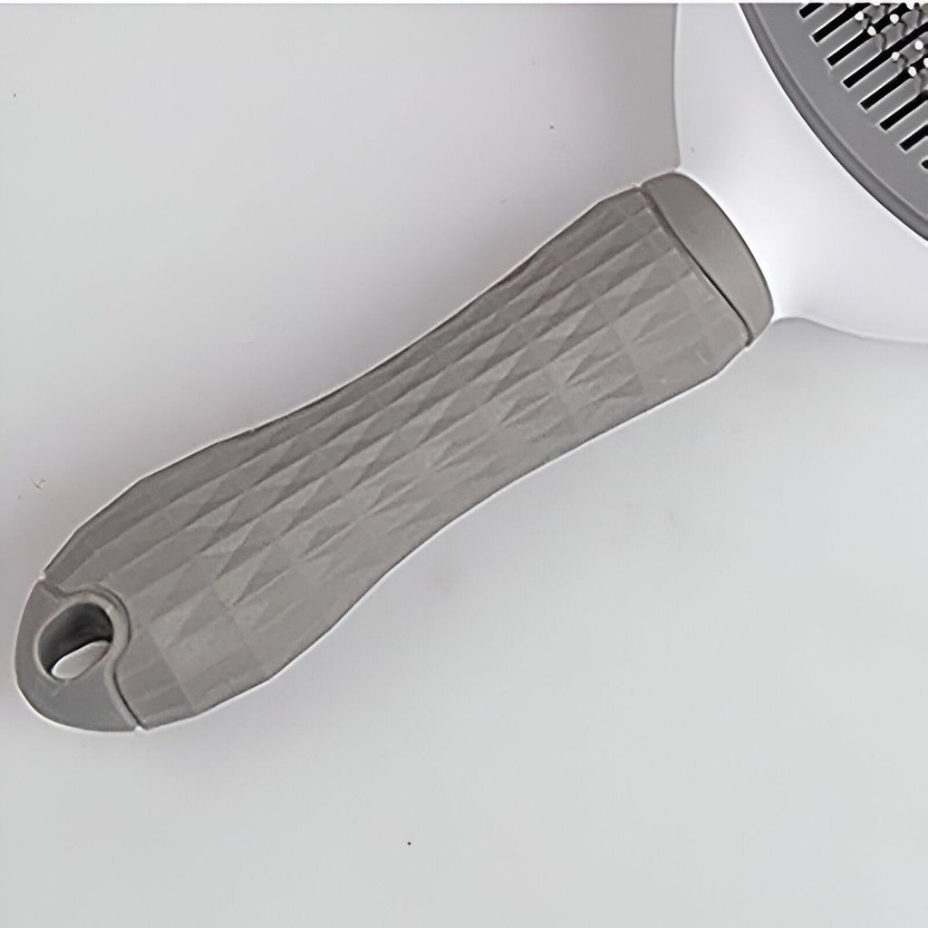 poignée de la brosse pour chien de couleur blanc et gris. Image produit Boutiquechien