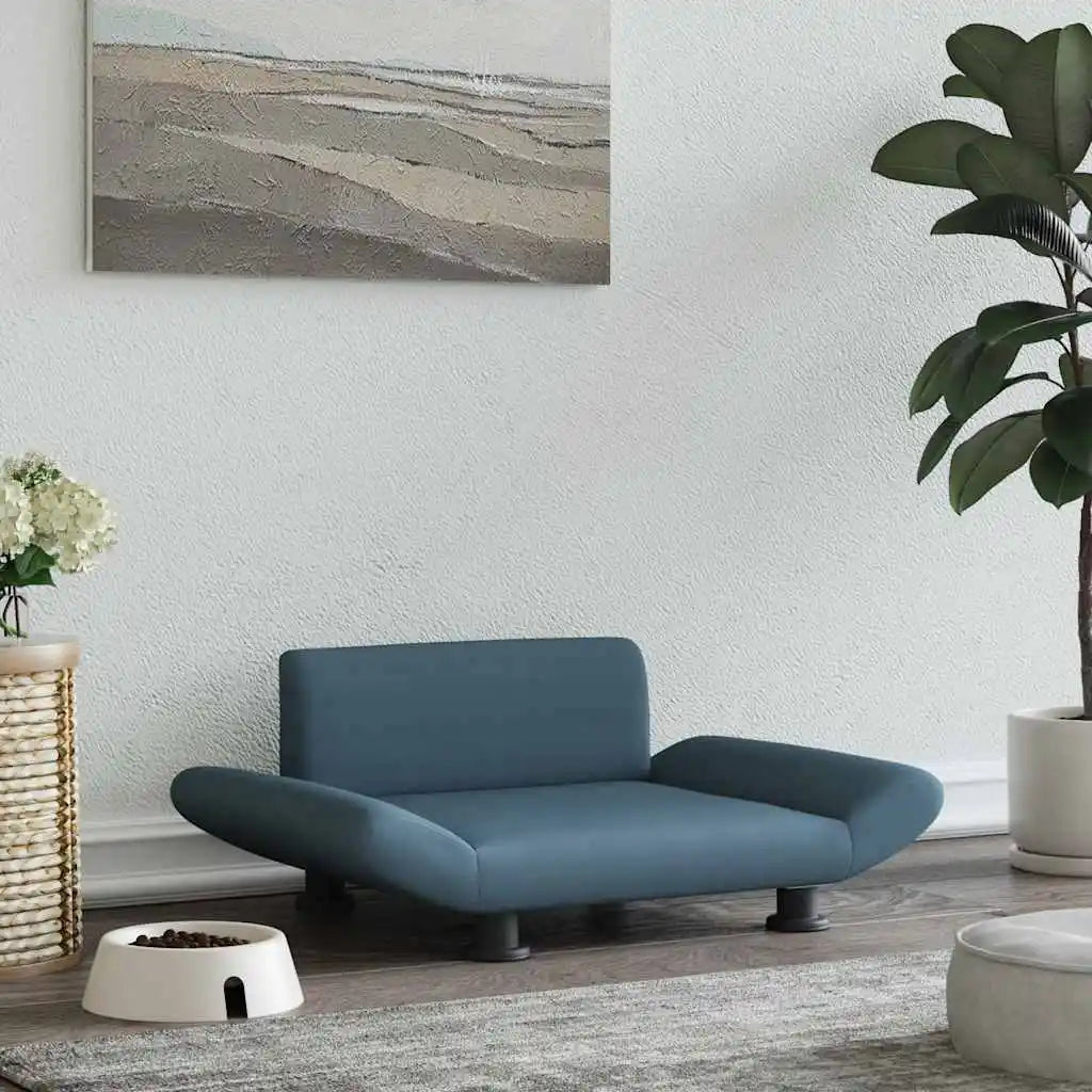 canapé pour chien de couleur gris foncé posé dans un salon de couleur claire. Sur le côté il y a une gamelle blanche et une plante verte. Image produit Boutiquechien