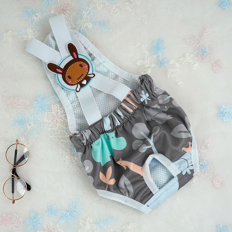 Couche à bretelle pour chien de couleur gris avec des formes de hippopotame. Le produit est posé dans un fond blanc. Image produit Boutiquechien