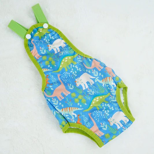 Couche à bretelle pour chien de couleur et vert avec des formes de dinosaures. Le produit est posé dans un fond blanc. Image produit Boutiquechien