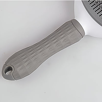 poignée de la brosse pour chien de couleur blanc et gris. Image produit Boutiquechien