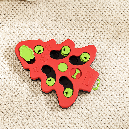 Puzzle pour chien en forme de Sapin de Noel de couleur rouge et vert. Le produit est posé sur un tapis gris. image produit boutiquechien