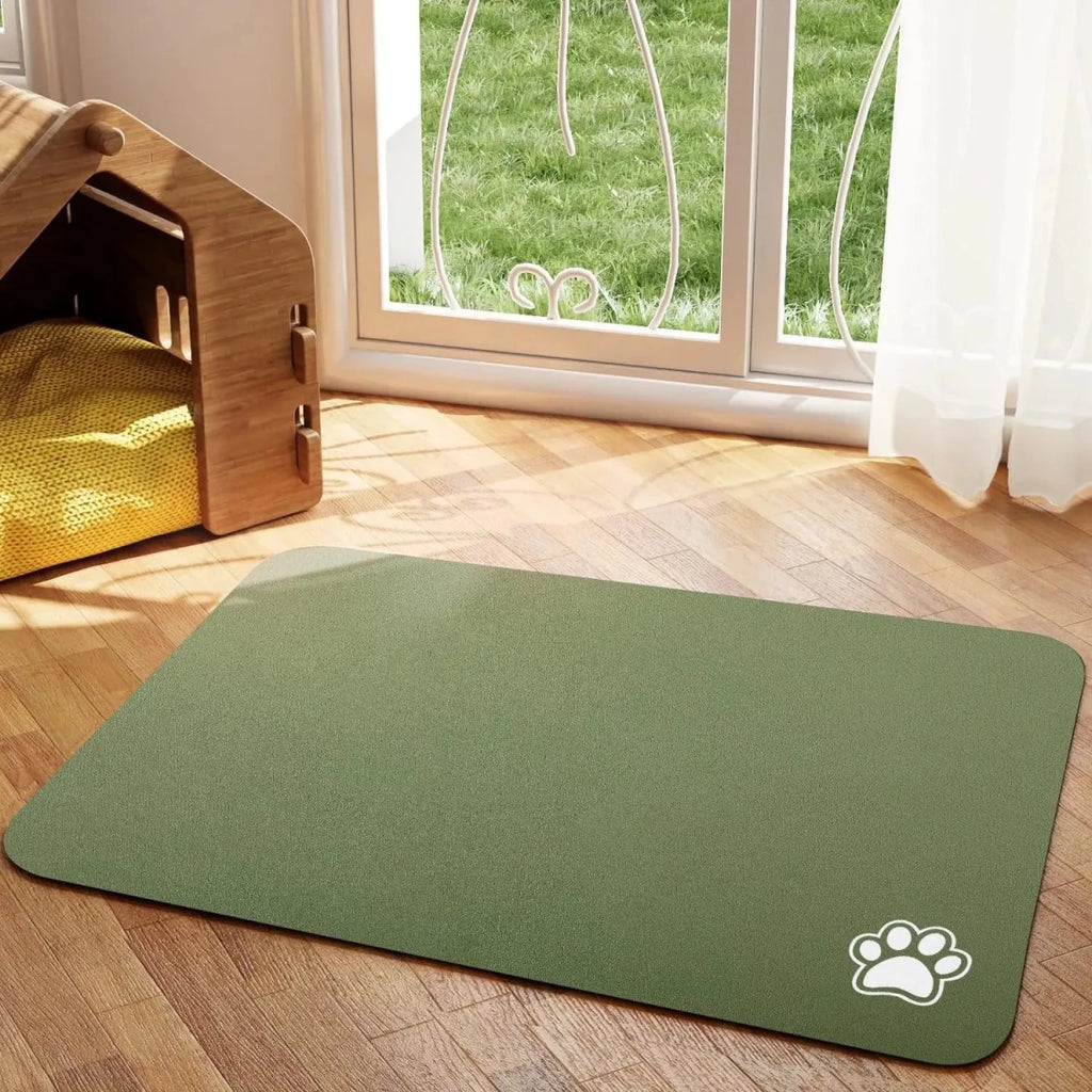 Tapis chien de couleur kaki avec une patte de couleur blanche sur le tapis pour gamelle de chien. Le tapis à gamelle pour chien est posé dans un salon avec sur le côté une niche en bois. Image produit Boutiquechien